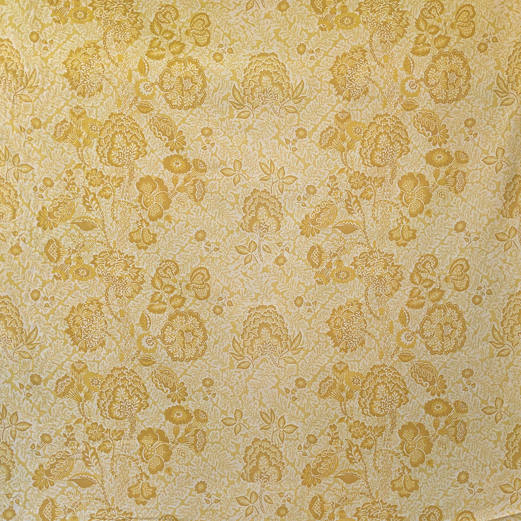Patterned fabric with yellow floral design on beige background
