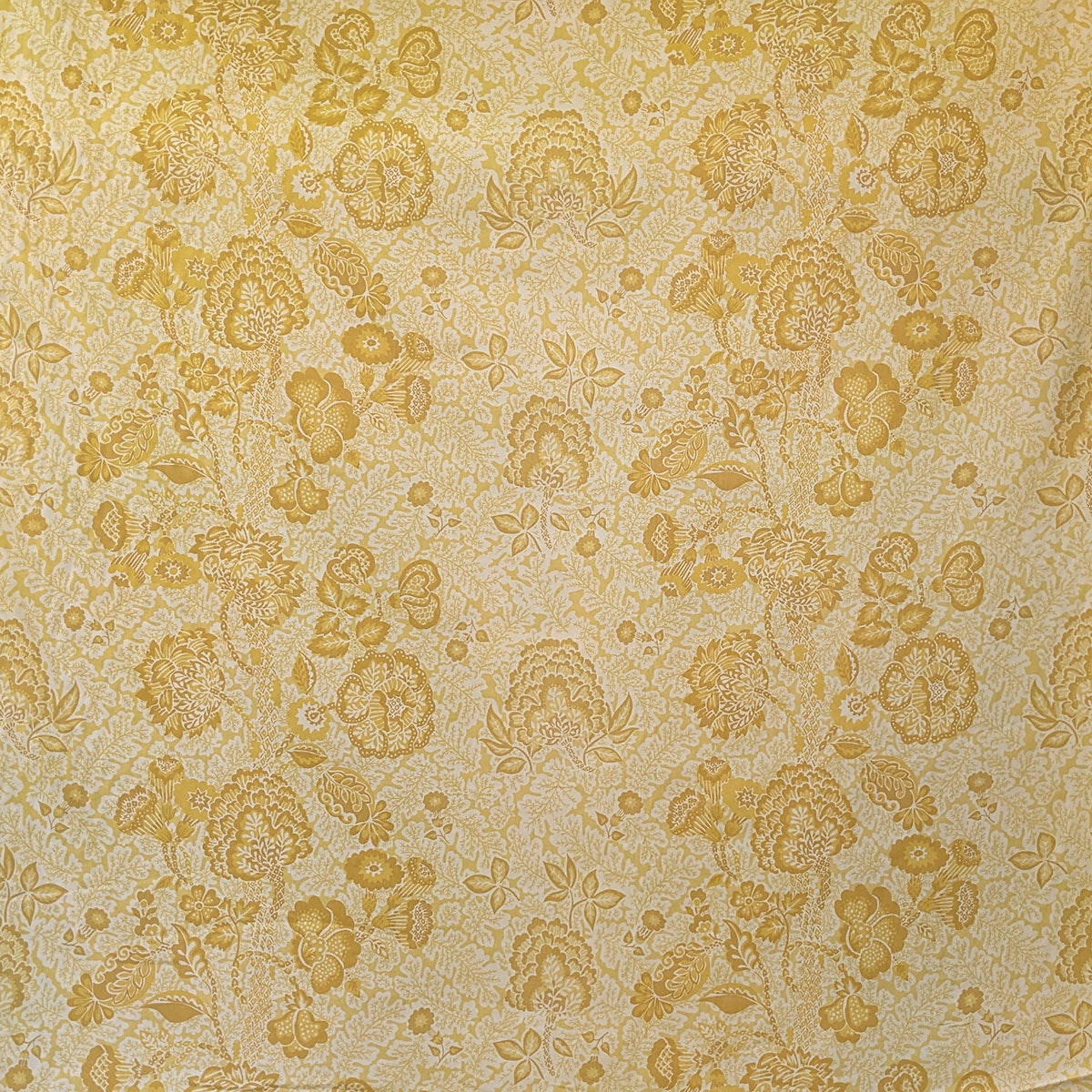 Patterned fabric with yellow floral design on beige background