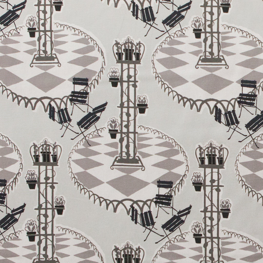 Garden patio scene on fabric in grey and black 
