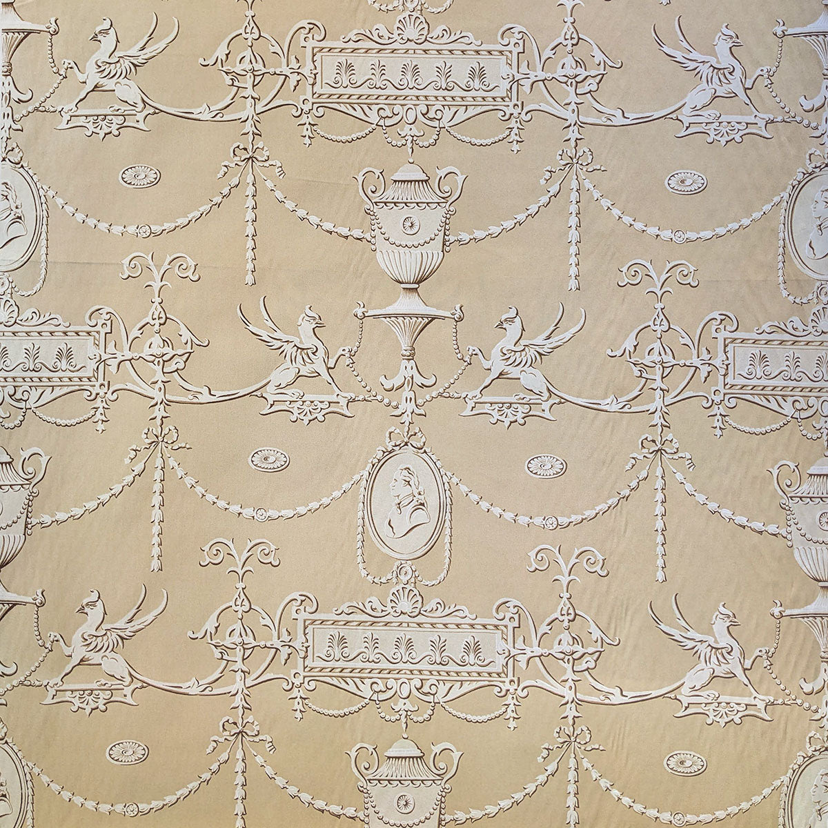 Decorative wallpaper with intricate white patterns on a beige background