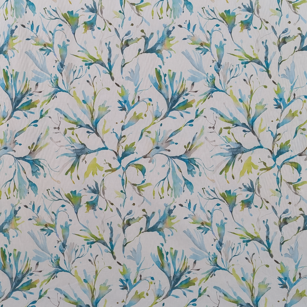 Patterned fabric with blue and green leaves on a light background