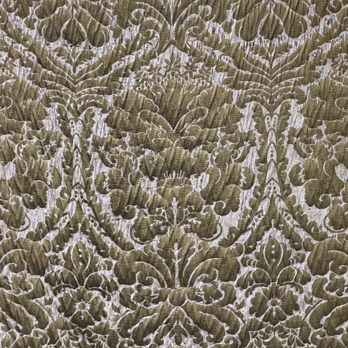 Close-up of a patterned fabric with intricate damask design