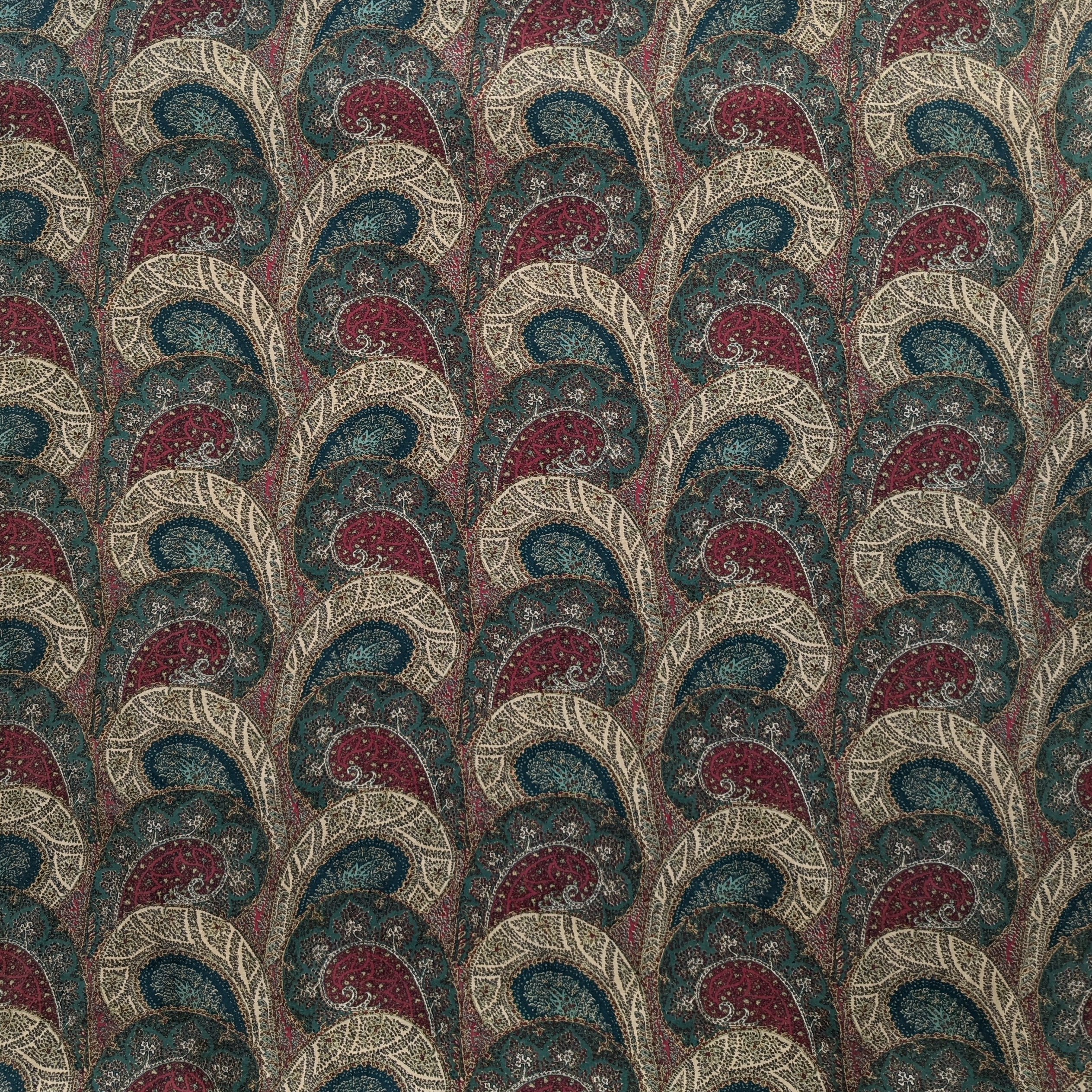 Paisley patterned fabric with a repeating design in red, blue, and beige.