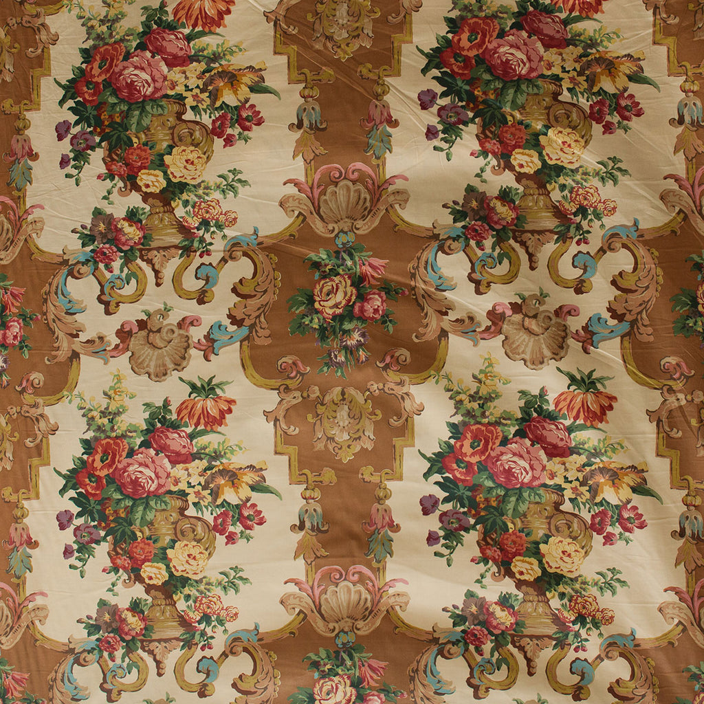 Decorative fabric with floral and baroque-style patterns on a beige background