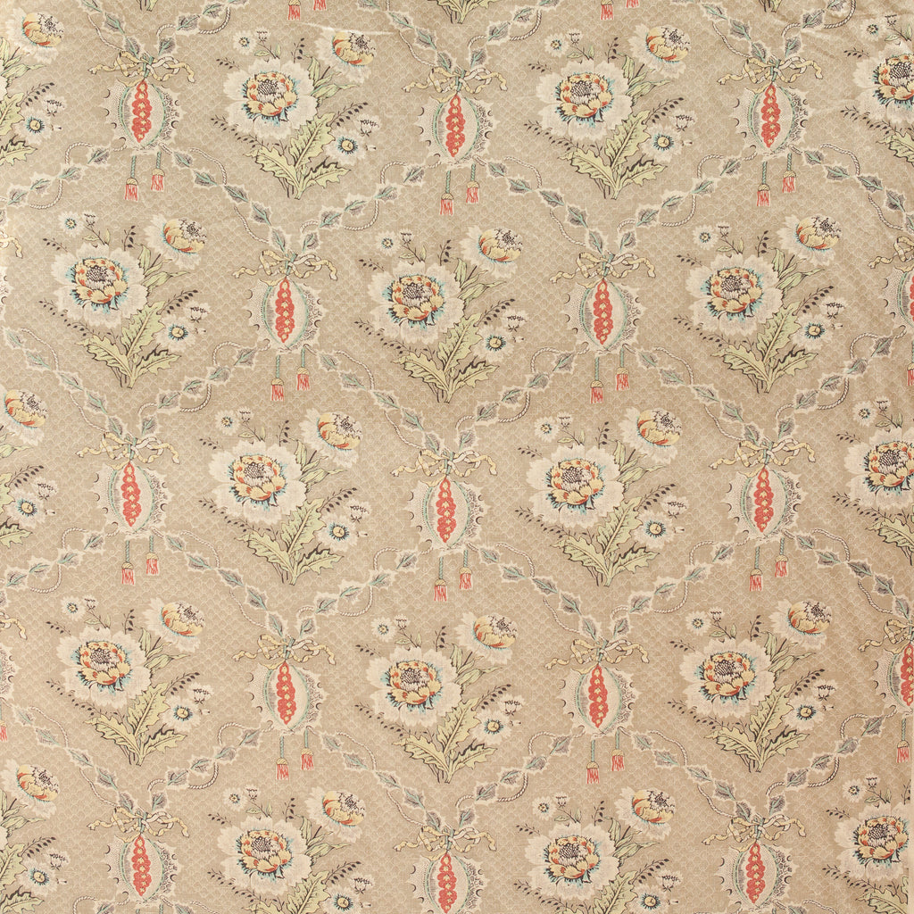 Patterned fabric with floral and leaf designs on a beige background