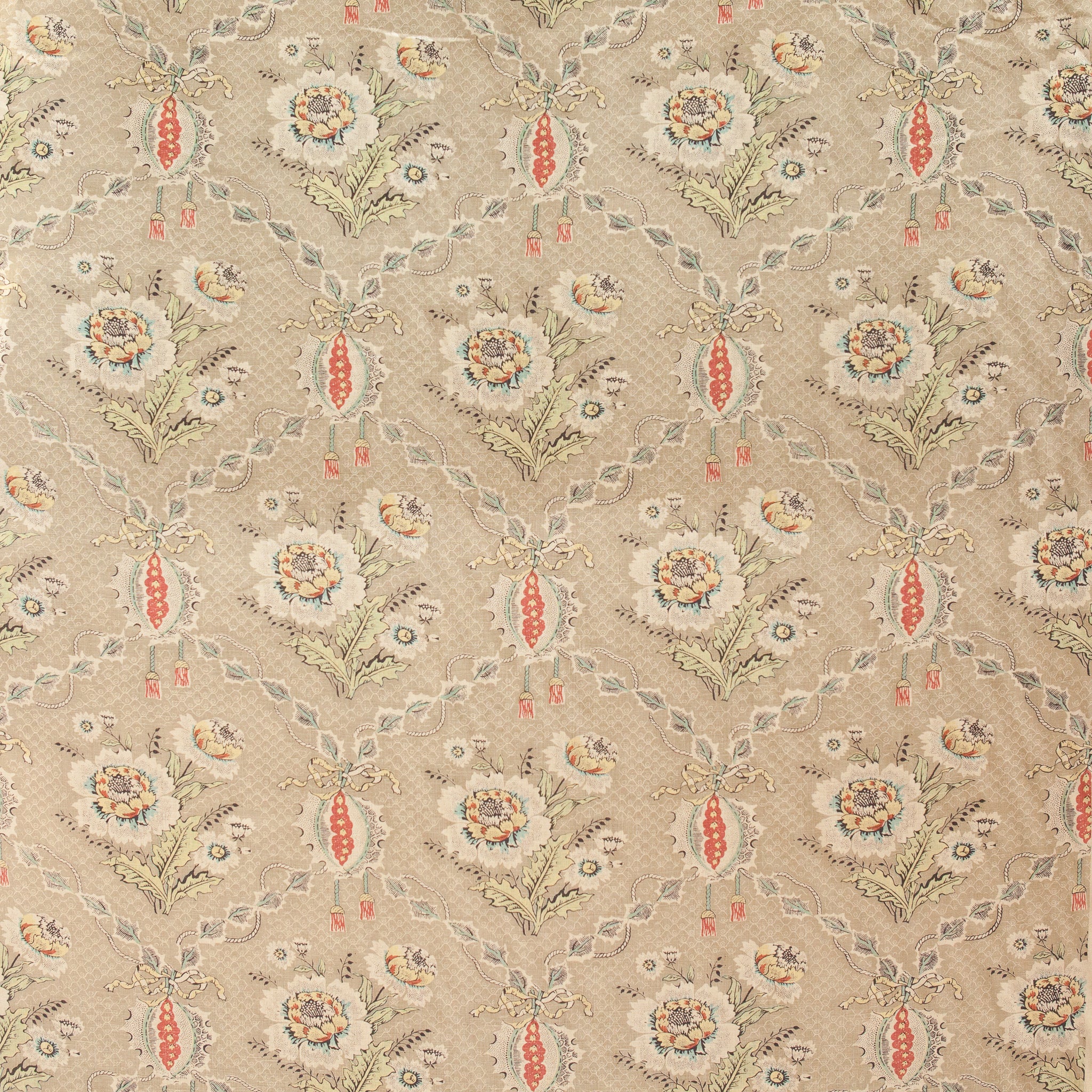 Patterned fabric with floral and leaf designs on a beige background