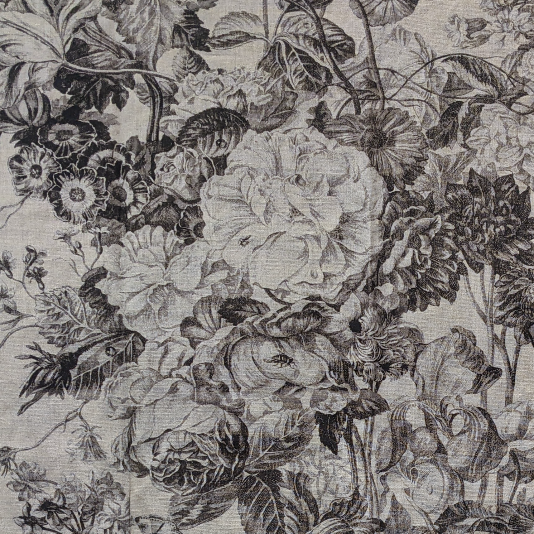 Floral pattern with black and white flowers on a textured beige background