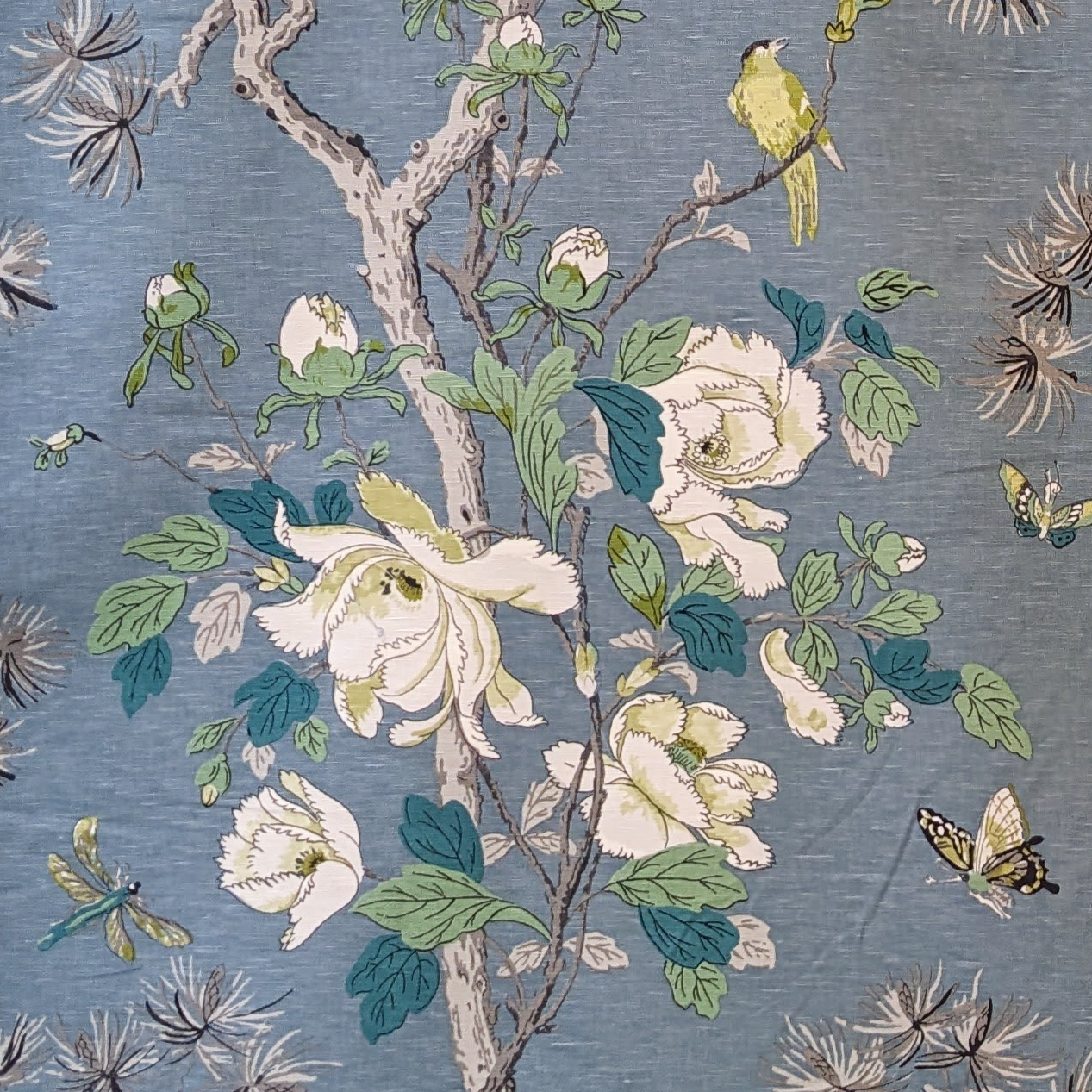 Floral and botanical pattern with flowers, leaves, and birds on a blue background