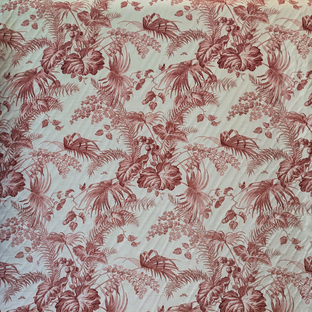 Floral patterned fabric with red and green colors on a light background