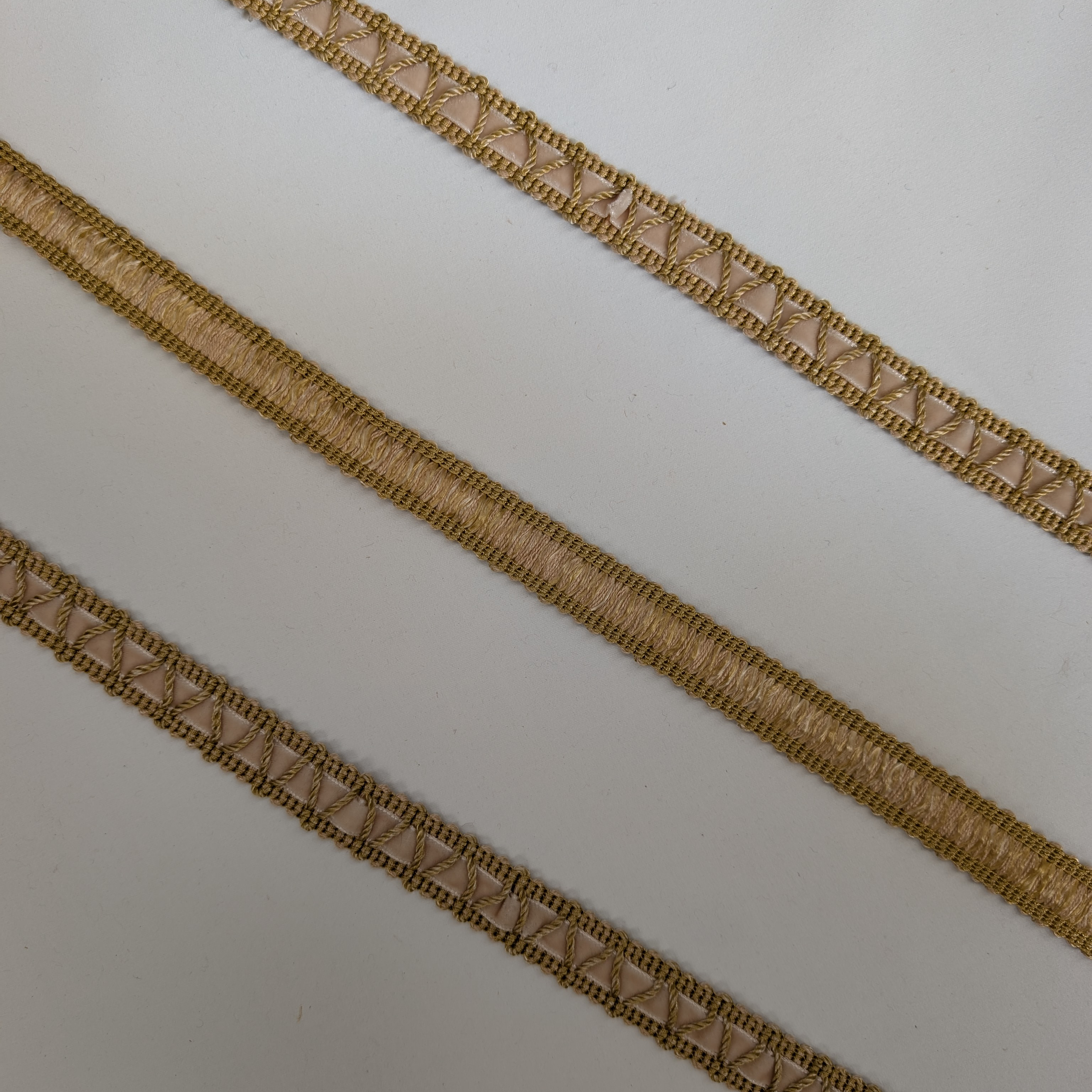 Two gold ribbons with a textured pattern on a white background