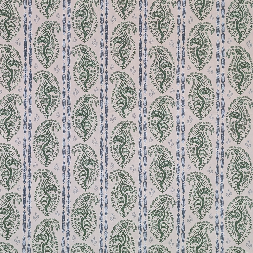 Patterned fabric with green and blue design on a white background
