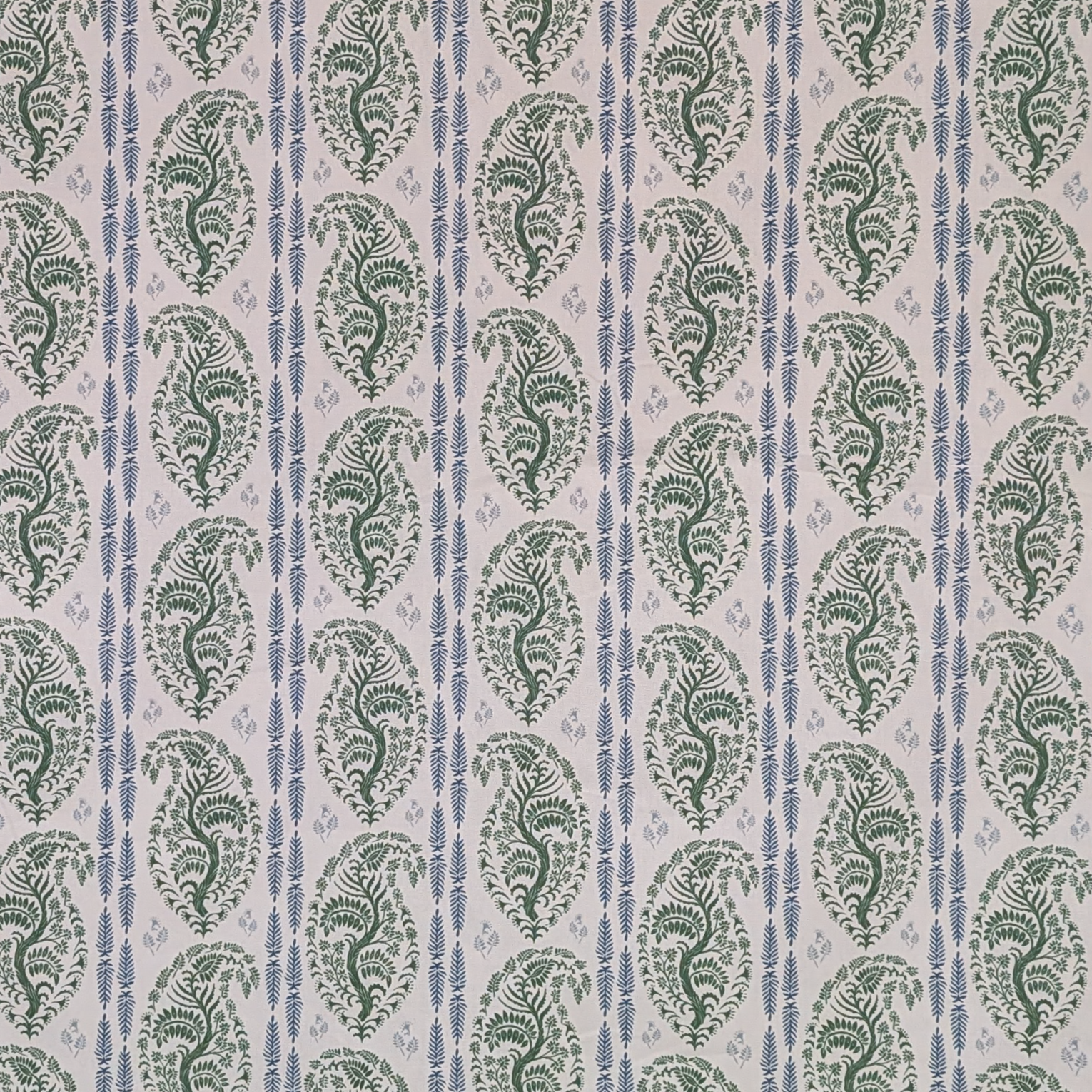 Patterned fabric with green and blue design on a white background