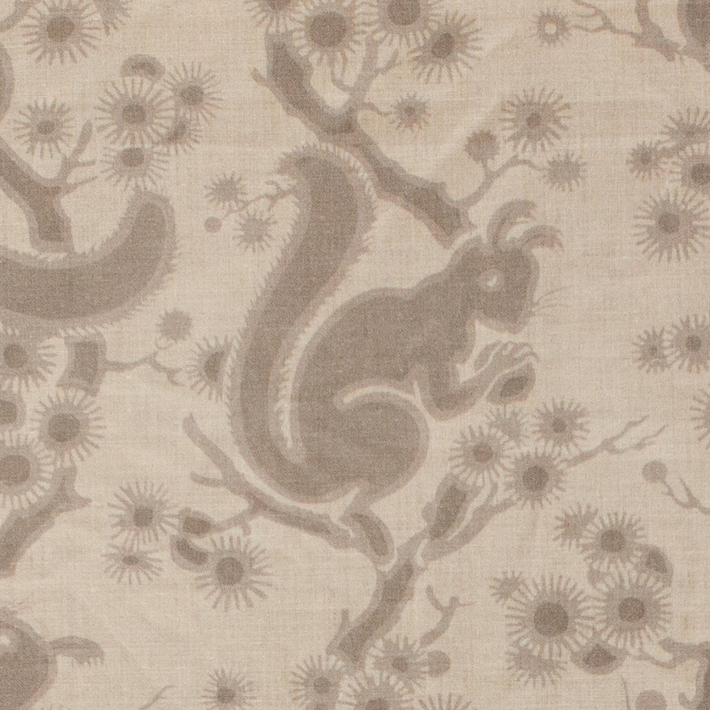 Patterned fabric with squirrels and branches on a beige background