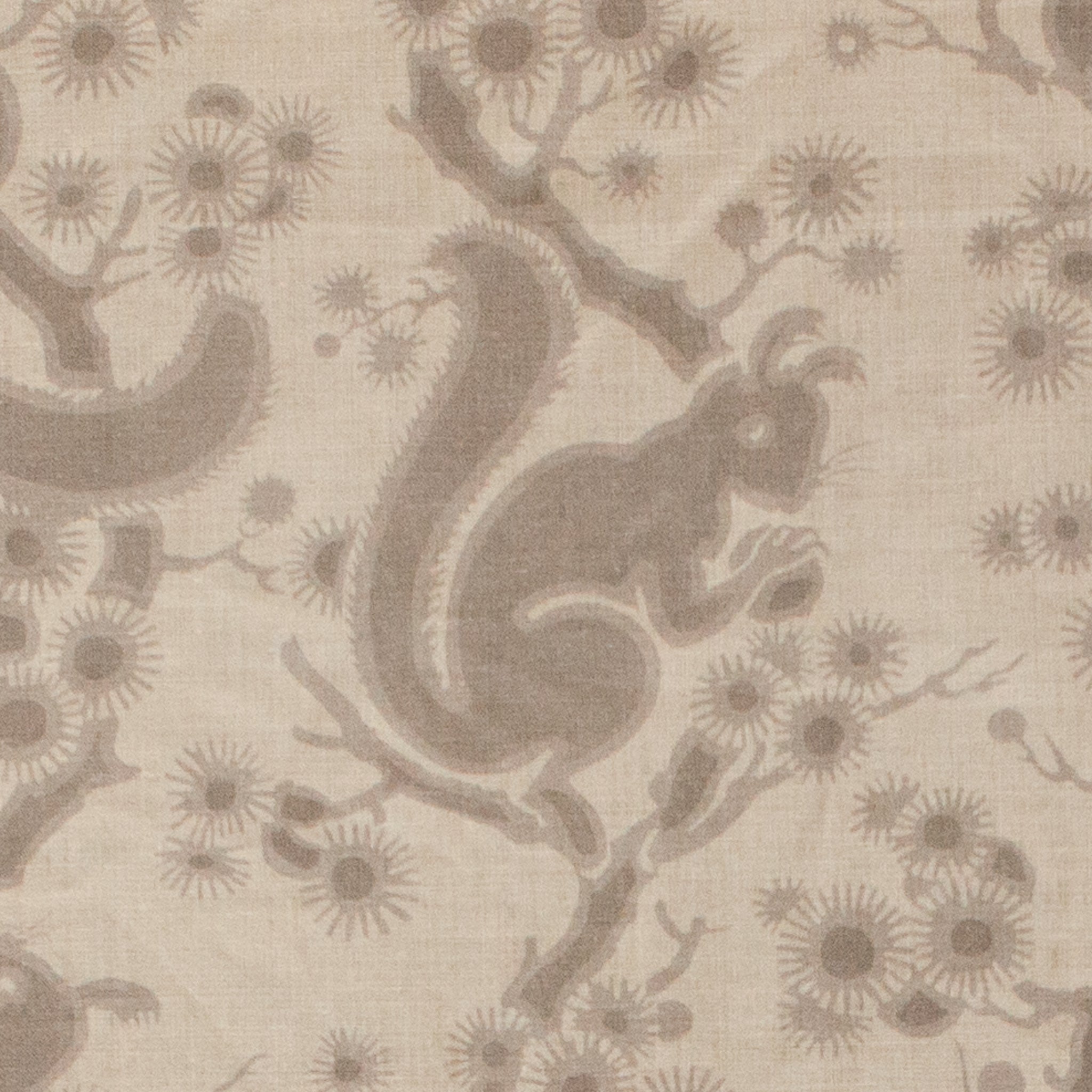 Patterned fabric with squirrels and branches on a beige background