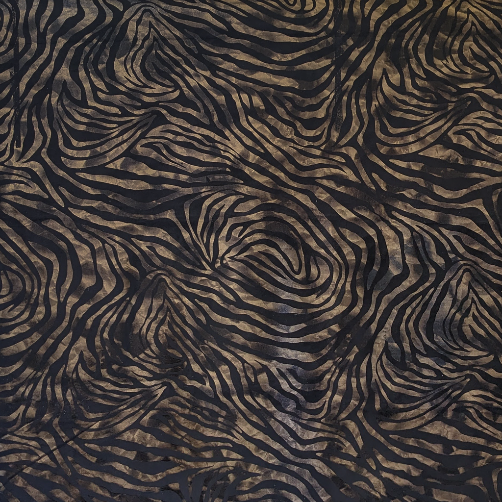Zebra print pattern in black and brown on a textured fabric background