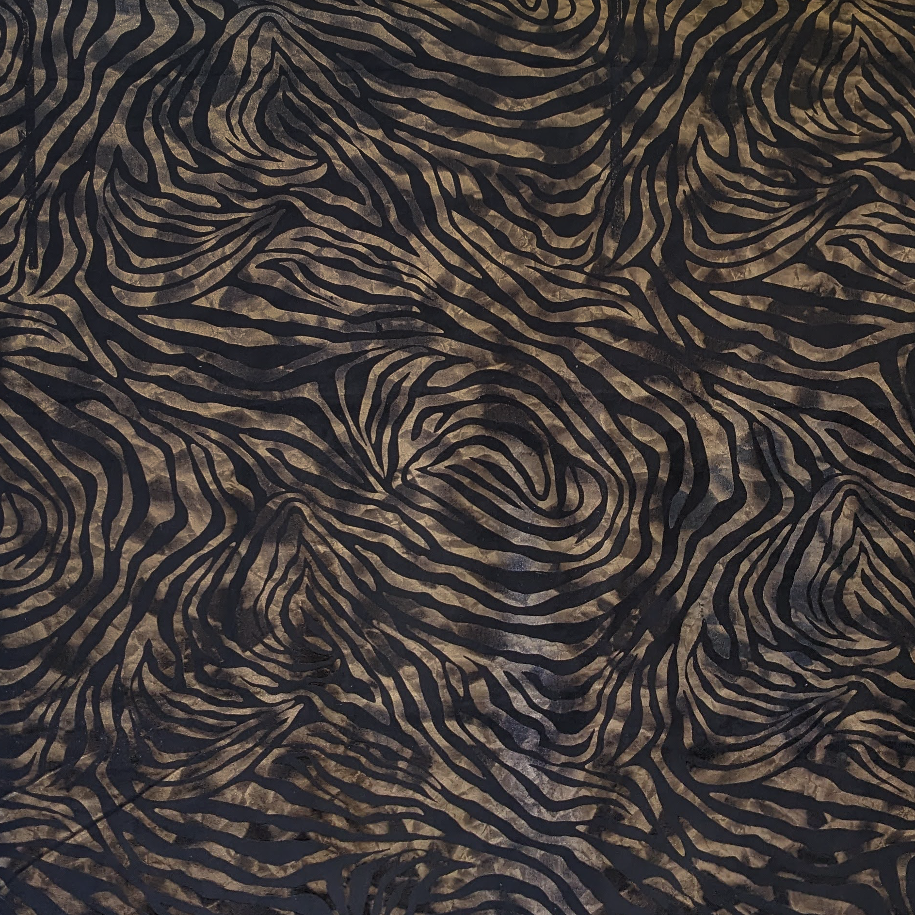 Zebra print pattern in black and brown on a textured fabric background