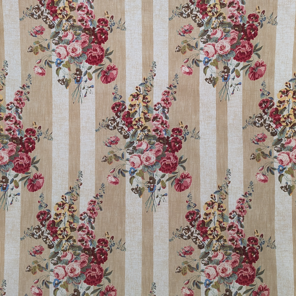 Floral patterned fabric with pink and red flowers on a beige and white striped background