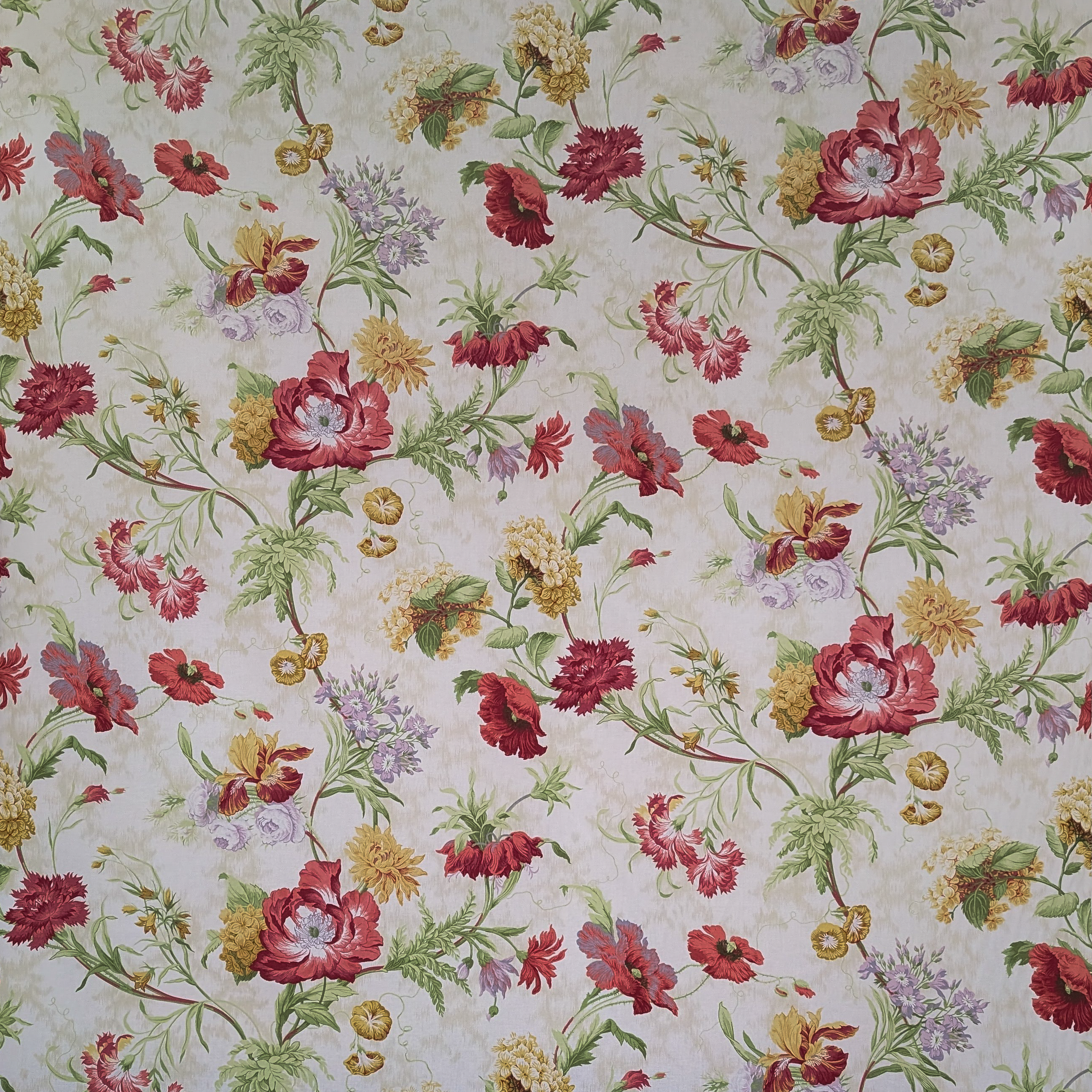 Floral patterned fabric with red, yellow, and green flowers on a light background