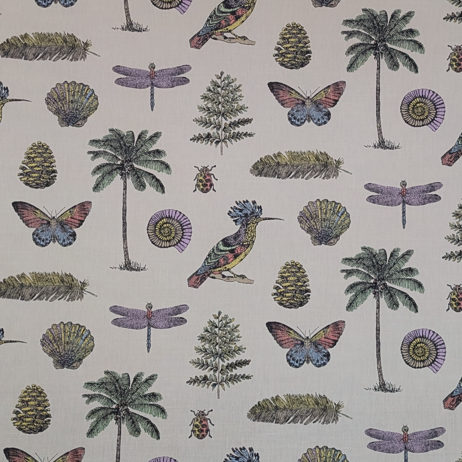 Patterned fabric with tropical elements including palm trees, butterflies, and dragonflies on a beige background.