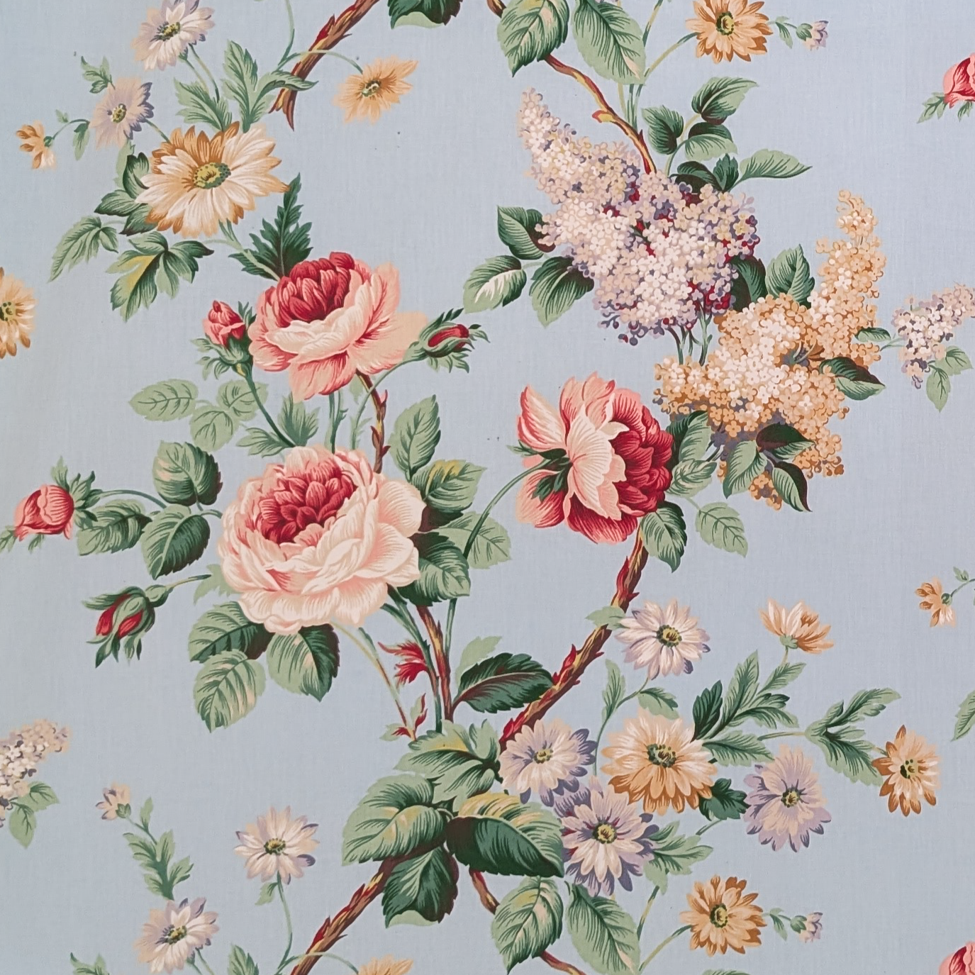 Floral pattern with roses and other flowers on a light blue background