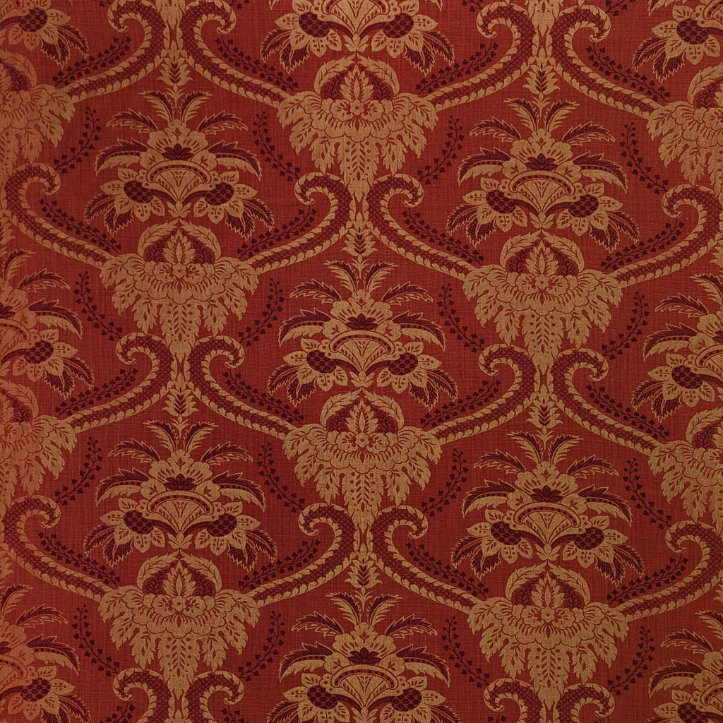 Decorative damask fabric pattern with intricate design on a red background