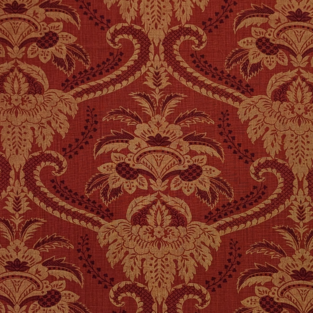 Decorative fabric pattern with intricate design on a red background