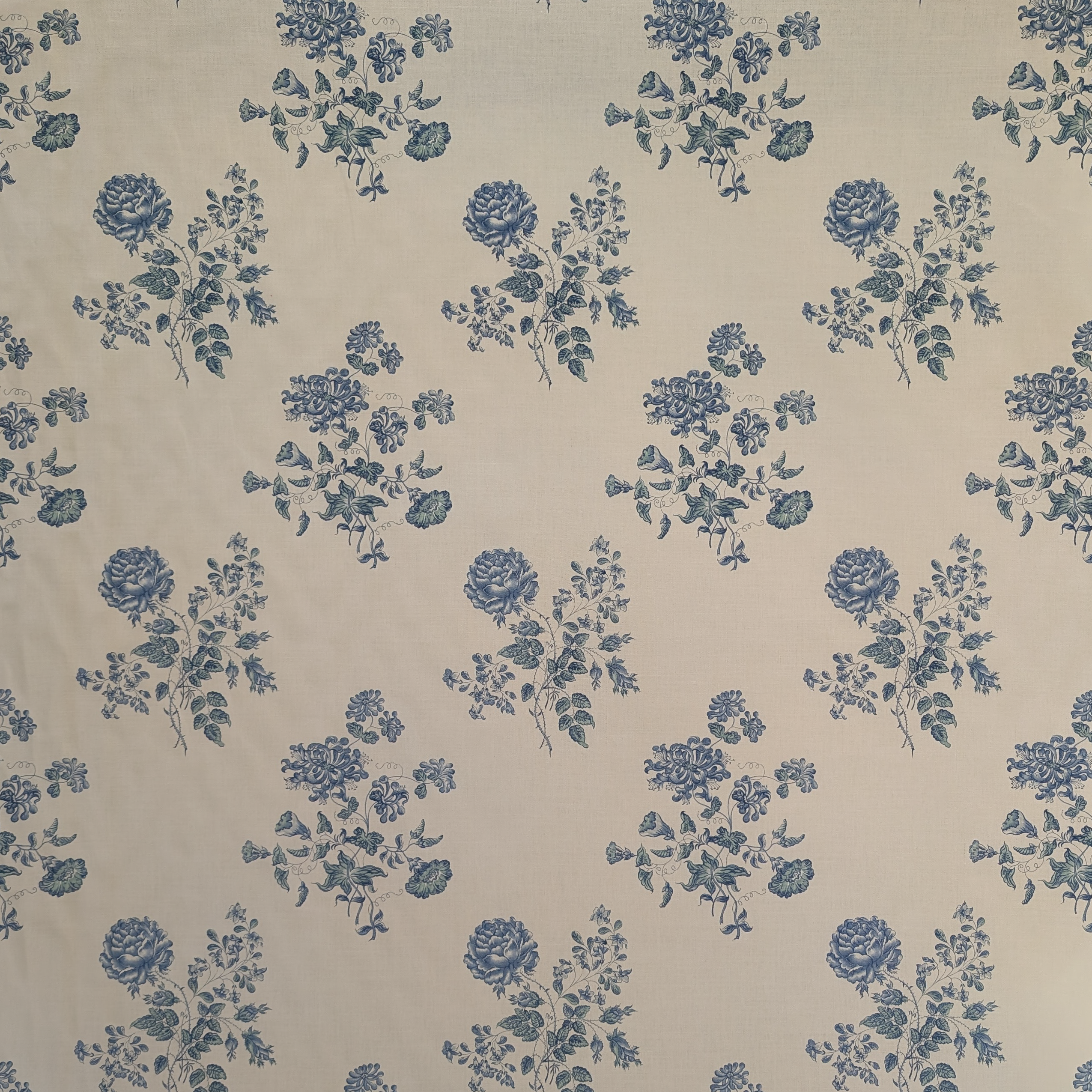Pattern of blue flowers on a beige background
