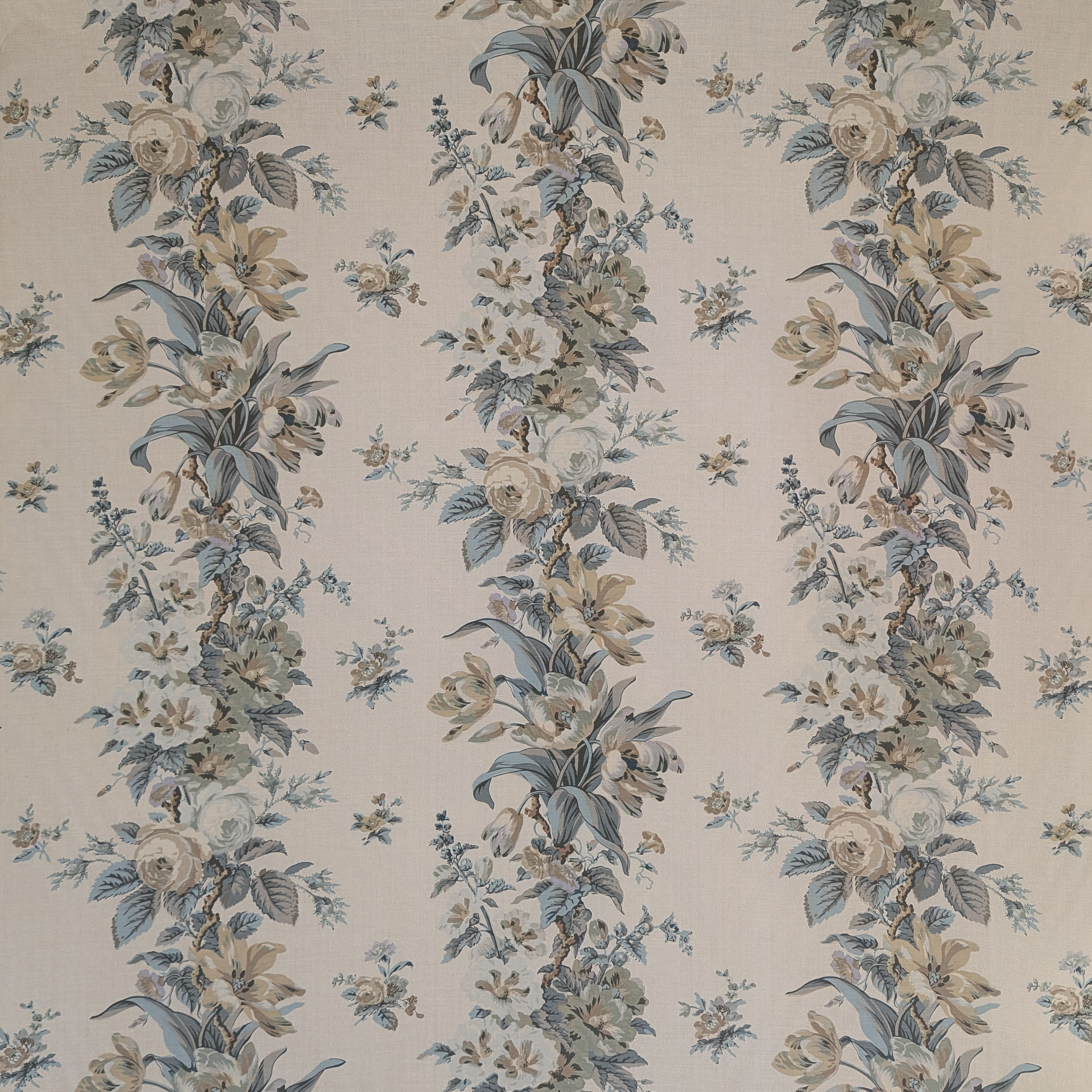 Floral patterned fabric with blue and beige flowers on a beige background