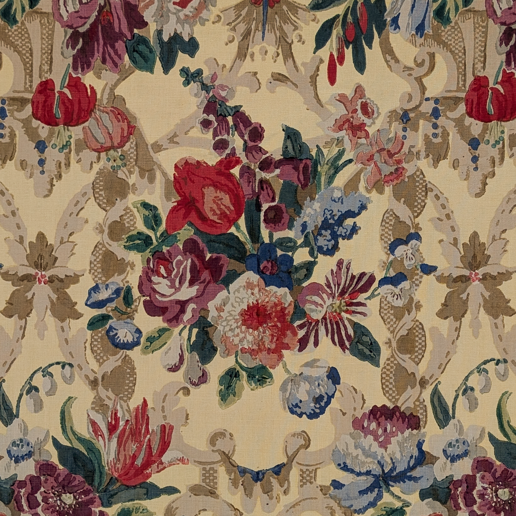 Detailed floral pattern with red, pink, blue, and green flowers on a yellow background